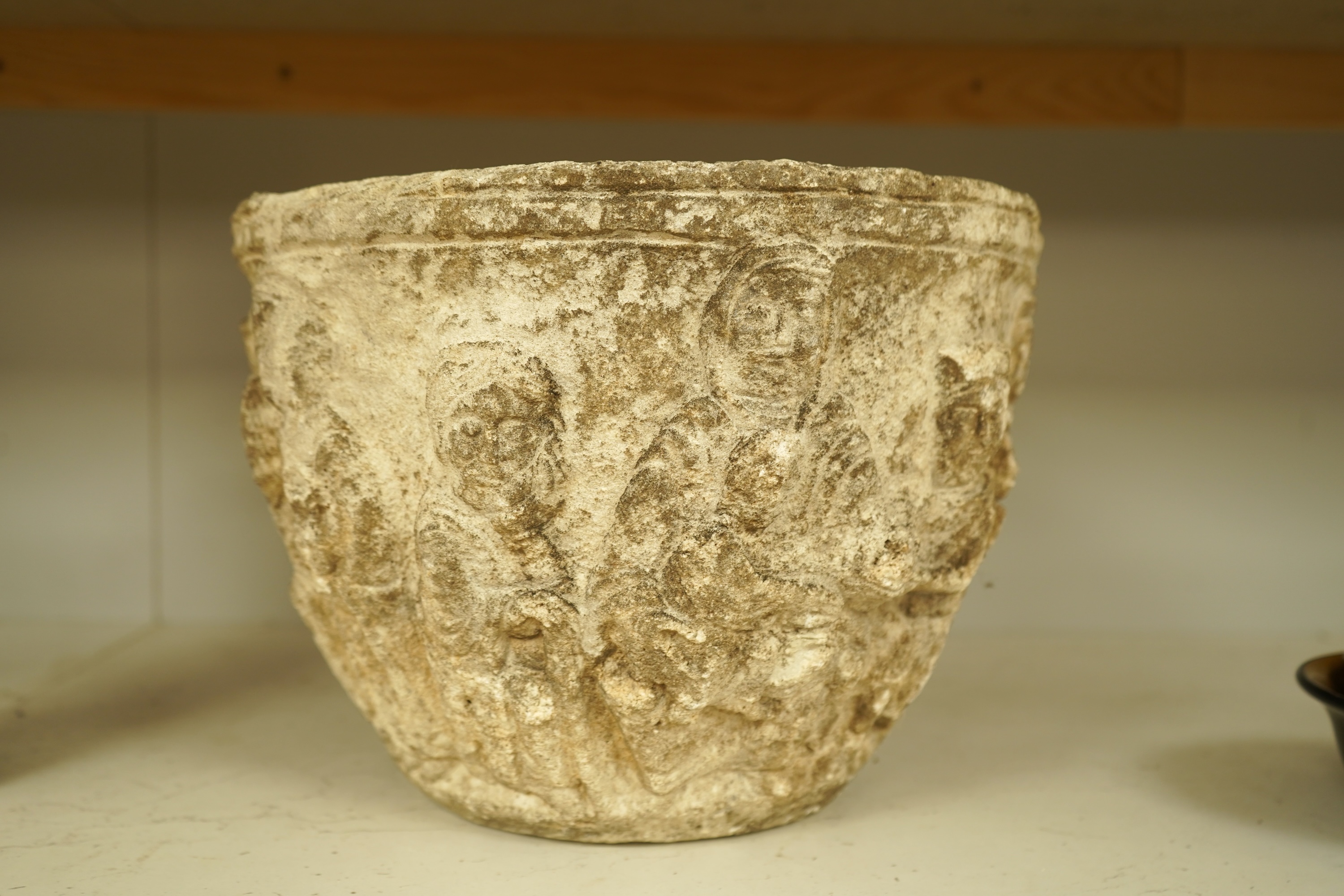 A Romanesque style reconstituted stone planter, 31cm in diameter